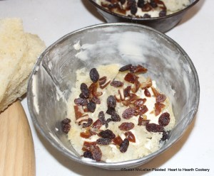 After the dish is buttered well, a layer of buttered white bread and sweet-meats are added-sliced dates and raisins