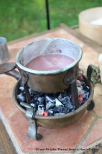 After the juice from the strawberries has had water and sugar added for the receipt (recipe) "For preserving strawberries" put that mixture into a sauce pan and scald.