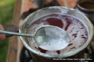After the scalding of the mixture of strawberry juice, added water and sugar for the receipt (recipe) "For preserving Strawberries", skim them.