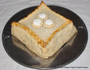 Pictured is the coffin filled with whole peaches, sugar, chips of cinnamon and cloves presented to table.  The receipt (recipe) for this coffin is "To bake Mellacattons".