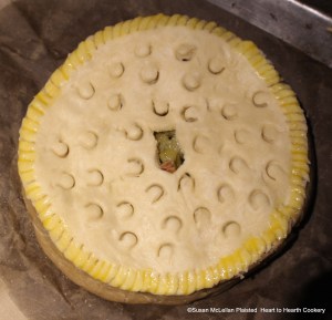 The fine paste cut lid to identify the coffin as gooseberry is placed on the pie and the edges washed with egg yolk. The receipt (recipe) "To bake preserved Gooseberries in pies" is now ready for the oven.