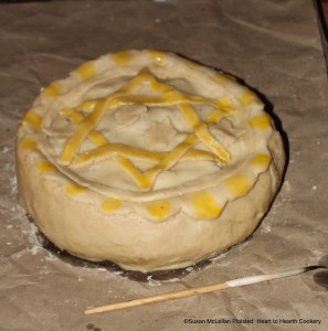 The 17th century lid design that indicates that the tart is a receipt (recipe) for a Cherry Tart has been applied with beaten egg yolk design highlights. The receipt "To make a Cherry Tart" is now ready for baking.