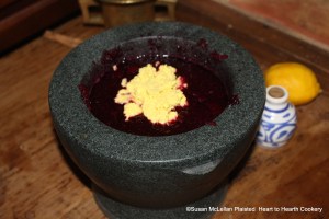 The "butter" made from egg yolks is then added to the beets and fine sugar in the mortar for the receipt (recipe) "To make Crimson Biscuit of Red Beet-Roots".