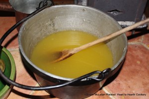 After the Seville orange juice infused with the grated peel of China oranges, lemons and Seville oranges has been mixed with the dissolved isinglass for the receipt (recipe) "To make Orange Jelly" stir it until it is almost cold.