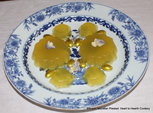 This is the second presentation of the receipt (recipe) “To make Orange Jelly” from the pineapple and patty pan molds. The jelly, made from the grated rinds of 2 China oranges, 2 lemons and 2 Seville oranges infused in Seville orange juice and jelled with isinglass, is garnished with candied Heart’s Ease and almond comfits gilded with gold leaf.