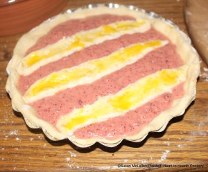 After the mixture of mashed strawberries, four egg yolks, and grated white bread has been strained for the receipt (recipe) To make a tart of strawberyes, then season it up with suger and swete butter.  The tart is now ready for baking.