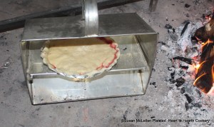 For the first baking of the receipt (recipe) To make a Rasberry Tart a tin baker was used.  The tin baker is placed in front of the bed of embers and fire and the reflective heat bakes the tart.  The tart must be rotated during this process for even baking.