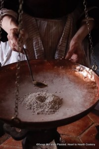 After the caraway seeds with 24 coats of sugar have rested for a day for the receipt (recipe) Caraway Comfits another twelve coats are added using small charges of sugar syrup. This will continue to occur until the comfits have 60 coats of sugar. Pictured is my adding the thirty-sixth charge of sugar syrup to be processed on the comfit pan and then the coated seeds will rest until my next opportunity to add twelve more layers.