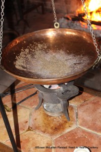 The first charge of sugar has been added to the caraway seeds on the comfit pan for the receipt (recipe) Caraway Comfits.