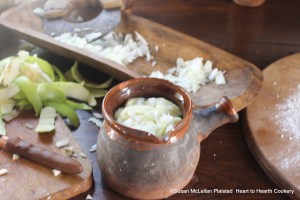 After the onions are minced and the apples are sliced for the receipt (recipe) To Butter Onions-Otherways put them in a pot but more apples than onions.