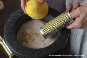 After the weight of fine sugar has been determined by the weight of the boiled potatoes on a balance scale for the receipt (recipe) To make Biscuits of Potatoes, grate some Lemon-Peel on the Sugar.  