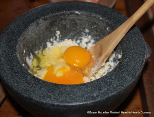 After two ounces of butter and a quarter of a pound of Cheshire cheese have been added to the mortar for the receipt (recipe) To make Ramakins, two eggs are added.