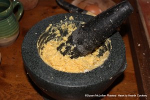 After the two eggs were added to the mortar for the receipt (recipe) To make Ramakins, the next step was to beat them fine with the mortar.