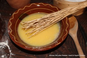 After sugar has been added to the whisked eggs for the receipt (recipe) Heesse Schpecksass (Hot Bacon Sauce), some apple cider vinegar and water are added.