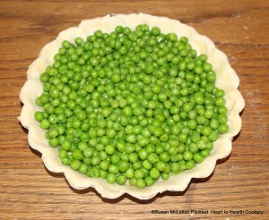 After the peas have been drained in the brass colander for the receipt (recipe) Green Peas Tart, then fill your tart.  The tart is now ready to be seasoned.