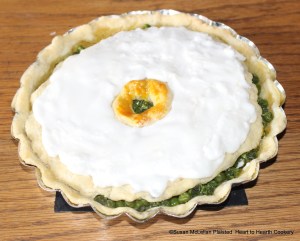 After the icing is prepared from egg white and sugar and the receipt (recipe) for Green Peas Tart baked in the tine baker, ice it.
