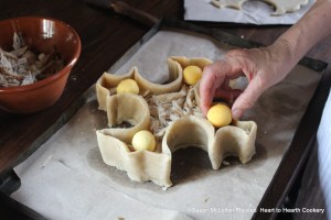 After roasted hen has been cut in pieces and laid in the pye for the receipt (recipe) A Hen Pye lay on balls yolks of hard eggs in the coffin.
