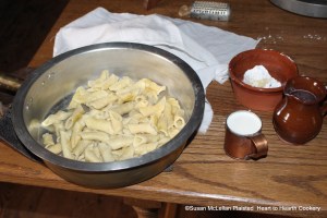 After the macaroni has been drained in a sieve for the receipt (recipe) Maccaroni then put it in a tossing pan, with about a gill of cream, and a piece of butter rolled in flour.  Pictured beside the tossing pan is a gill cup full of cream and a small red ware bowl with the butter for rolling in the flour.