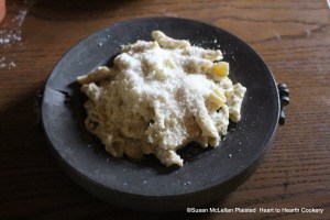 After the hot water has been funneled into the water plate for the receipt (recipe) Maccaroni, the pasta with the cream sauce is placed onto the heater plate and Parmesan cheese is added.