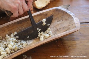 After the salsify is half boiled for the receipt (recipe) Stewed Salsify cut it up.  A rocker knife was very efficient for this process.
