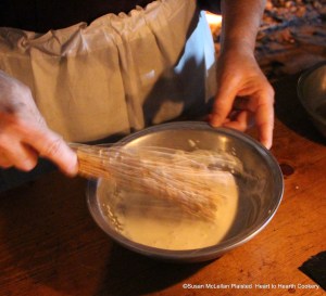 After a little of the sack (very dry sherry) and a little of the cream have been added together in a pewter bowl for the receipt (recipe) To make a very fine Sillabub beat them till it froth. Pictured a birch twig whisk is being used to create the froth and the froth (bubbles) is the most important part of this receipt.