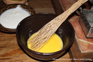 While the milk is coming to a boil for the Pennsylvania German receipt (recipe) for Egg Cheese, whisk the four fresh eggs until lemon colored.