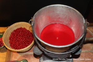After a half pint of currant juice is made from a pound of red currants for the receipt (recipe) To preserve red CURRANS whole, the half pint is added to the preserving kettle to start the preserving process for the  two pounds of fresh red currants in the rye straw basket.