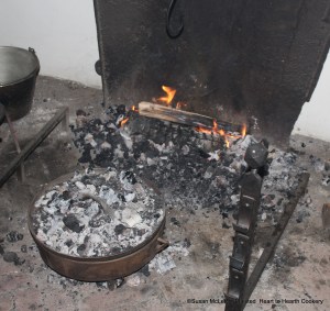 After the receipt (recipe) A Goose Bery Pudding was poured into the baking dish with paste (pastry crust) about the brim, it was baked inside a reproduction of an original bake kettle.  Note the shape of the ears on the kettle and that there is no attached bail.  A hinged, removable bail was used to move the bake kettle and attached when needed.