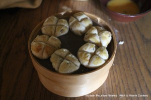 After the receipt (recipe) To make Wigs was laid before the fire to rise a quarter pound of sugar was worked in, the paste rolled in small balls and marked with a knife to form wedges. The word wig has a Dutch origin meaning wedge. The first wigs baked in a tin baker are cooling on a sieve.