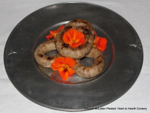 After the puddings were browned on the gridiron for the 1673 receipt (recipe) To make a pudding of French Barley, the puddings were served on a pewter serving piece with edible nasturtiums.  To the eye, this receipt may remind you of sausages but at the time of this receipt  puddings were anything put in something and closed on both ends.