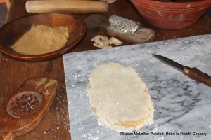 After the almond paste has been laid "even" on one of the sugar plate cakes for the receipt (recipe) To make White Gingerbread cover it with an other.  There are now three layers-sugar plate, almond paste and sugar plate.