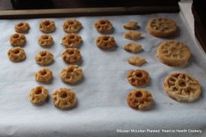 After the layers of sugar plate and almond paste have been strewn with ginger above and beneath and molded for the receipt (recipe) To make White Gingerbread the cakes were laid on white paper on a drying rack to dry.