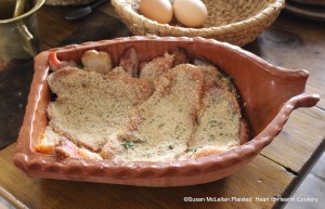 After the veal has been seasoned with pepper, salt, mace and nutmeg for the receipt (recipe) Veal Collops another Way strew them with crumbs of bread, shred parsley. The bacon has been neatly laid in the bottom of the rutcher and the seasoned collops with bread crumbs and parsley laid on top of the bacon.