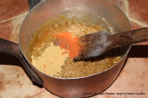 After the boiled honey and grated bread has been stirred well together for the receipt (recipe) To make gingerbrede take it down and put erin ginger, longe pepper & saundres.  My saucepan has been taking down from the heat of the brazier and spices and coloring added.