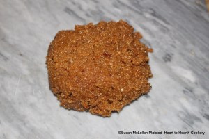 After the honey and grated bread crumb mixture has been taken off the fire and the ginger, long pepper and sanders added for the receipt (recipe) To make gingerbrede tempere it vp (up) with in handes.  The mixture is very stiff and sticky and the spices and coloring need to be thoroughly mixed by hand.  I am doing this on marble.