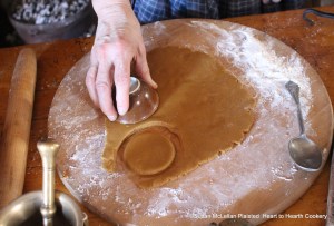 After the flour has been added to make the Bread stiff for the receipt (recipe) To make Ginger-Bread Cakes roll it out ... and cut them out with a Tea Cup.
