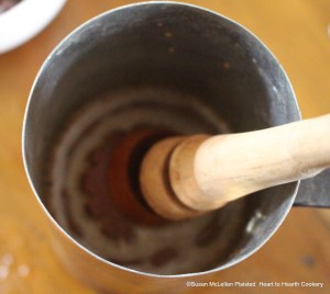 The effect of using the molinillo mixing the grated chocolate cake with hot water in the chocolate pot is to produce the important froth that was expected when serving the chocolate beverage. Now that the froth is present, the receipt (recipe) To make Chocolate is ready to be poured into chocolate cups.