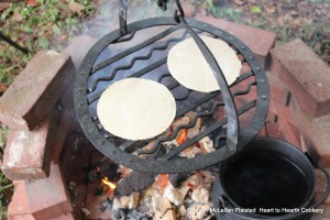 A girdle was used in the Highlands of Scotland for baking oat bannocks.  Most commonly used was a flat iron girdles but a variant of the plain flat girdle was the barred girdle.  The barred girdle were made with narrow bars of iron with some bent into pleasing designs.  Pictured is my reproduction barred girdle with oat bannocks.