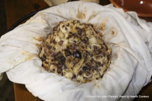 After the pudding bag with the receipt (recipe) A Boiled Plumb-Pudding inside has been hung to set the pudding for an hour, the string is carefully cut without hurting the linen pudding bag and opened to reveal what will be the bottom of the pudding. Next place the bottom on the serving dish, making certain the linen bag is free and then very carefully and slowly start peeling away the cloth from the pudding being very careful not to remove any of the pudding with the bag.