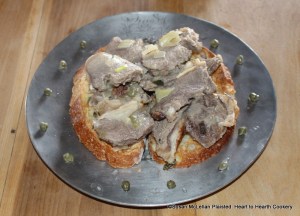 To Harsh a Roast of Mutton receipt (recipe):  Half roast your Mutton at a quick fire, cut it in thin slices, stew it with Gravy, sweet Marjoram, and Capers, and Onions, three Anchovies, two Oysters, half a Nutmeg, half a sliced Lemon, stirre this all well together with the meat, let it stew till it be tender in a dish, then break three or four yolkes of Eggs, throw it in the dish with some Butter, toss it well together and dish it with sippets.  The picture shows the receipt garnished with capers and ready for the table.