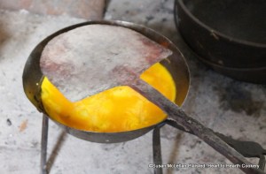 When the mixture of eggs, cream and salt have been cooked enough in the spider for the receipt (recipe) An Amulet of Asparagus a red-hot salamander is used to finish the top.  