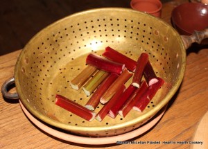 In the 1739 letter from Peter Collinson to John Bartram, Peter writes an actual receipt (recipe) for To make rhubarb tarts. All you have to do, is to take the stalks from the root, and from the leaves, cut them in two or three pieces, and peel off the rind. Pictured in my brass colander are stalks cut in three pieces with the rind still on.