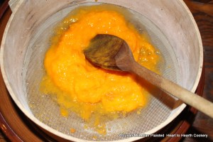 After the apricots have been stewed tender for the receipt (recipe) Apricot Puffs mash them with a spoon and rub them through a sieve.