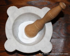 The first step in the preparation for the receipt (recipe) Chocolate Puffs is to take half a pound of double-refined sugar and beat it.  Double refined sugar is sugar that has gone through the claying process in sugar molds twice and is whiter than most of the sugar from the refining process.