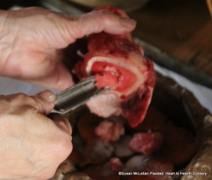 After the Spanish Potatoes nutmeg, cinnamon, ginger and sugar for the receipt (recipe) To make a Potato Pye add to them the Marrow.  I am removing the marrow from a marrow bone with a marrow spoon.