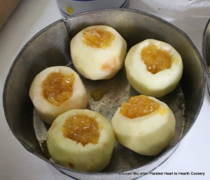 After the apples were pared and cored with a scoop for the receipt (recipe) Snowballs fill them with marmalade.  The apples are in the tin baking pan to make certain they would fit and filled with Seville orange marmalade.