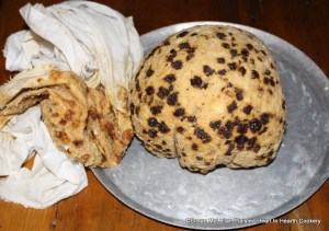 After the receipt (recipe) A plum puding Boyled has hung to rest for an hour the string is untied and the cloth removed very slowly and carefully.  The pudding is now ready to be dished and a butter based sauce ladled over for a beautiful gloss.