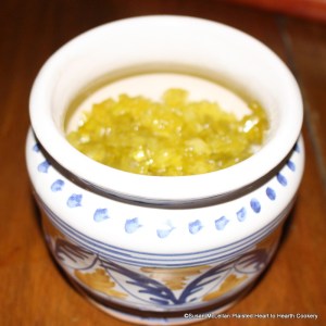 After the small pieces of the rind of the citron melon have boiled gently in the syrup four hours for the receipt (recipe) The American Citron then put it in pots for use. Pictured is the completely translucent pieces of preserved American citron melon rind in a gally pot ready to be used as an ingredient in receipts or as garnish.