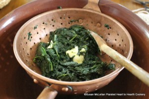 After the young spinach has been stewed tender with butter and salt for the receipt (recipe) To make Spinach Toasts squeeze out the water, put in another lump of butter.
