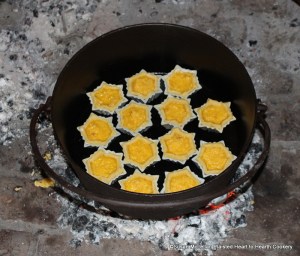 After the paste (pastry) is rolled out for the receipt (recipe) Orange Cheese-cakes with a Past for Them, patty pans were lined with the paste and filled with mixture containing almonds and candied orange peel beat fine. The cheese-cakes are pictured in an original 18th century bake kettle ready for baking.